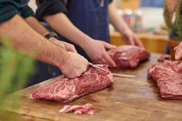 Trimming British grass-fed beef blade for butchery class